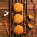 Creative Moon cake Mooncake table design - Chinese traditional pastry with tea cups on wooden background, Mid-Autumn Festival