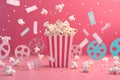 Creative movie night concept with popcorn explosion, film reels, and cinema tickets on pink? Royalty Free Stock Photo