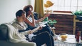 Creative musical duet is practising at home woman is singing in microphone and man is playing the guitar. Young cheerful Royalty Free Stock Photo