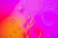 Creative neon background with drops. Glowing abstract backdrop with vibrant gradients on bubbles. Purple, red and orange