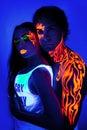 Creative neon light man and woman beauty make up body art