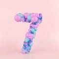 Creative number seven 7 concept made of colorful pastel balloons. Balloon font concept on pastel pink background