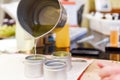 Creative occupation of candle making showing the pouring of liquid wax into jars Royalty Free Stock Photo