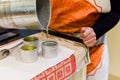 Creative occupation of candle making showing the pouring of liquid wax into jars Royalty Free Stock Photo