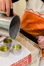 Creative occupation of candle making showing the pouring of liquid wax into jars Royalty Free Stock Photo