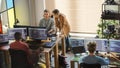 Creative Office: Diverse Colleagues Coding on Desktop Computers With Multiple Monitors. Female