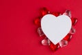 Creative outline with red glass hearts, paper heart on red pastel background. Top view, flat lay. Valentine's day