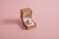 Creative pastel Valentine's Day composition made of pink gummy bear and engagement ring box. Minimal concept