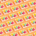 Creative pattern made of colorful macaroons on white wooden tray on orange background. Dessert and confectionary