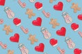 Creative pattern made with homemade Christmas  Gingerbread cookies isolated on pastel blue background Royalty Free Stock Photo