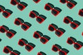 Creative pattern made of red sunglasses on pastel background. Vacation and travel concept. Trendy fashion beach accessories. Royalty Free Stock Photo