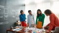 Creative people. Professional team of young web designers working on a new project together and discussing ideas while Royalty Free Stock Photo