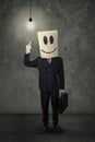 Creative person with a carton head and lamp Royalty Free Stock Photo