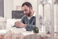 Ingenious designer watching at model of a house