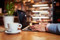 Creative person working on laptop in cafe