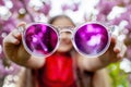 Smiling girl behind purple sunglasses, cherry blossoms Royalty Free Stock Photo