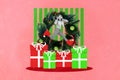 Creative photo collage illustration of playful cheerful good mood girl jumping on gifts listen misc isolated on pink