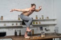 Creative photo of muscular man in the kitchen balancing eggs
