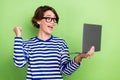 Creative photo of young gambling addicted funny woman wear glasses fist up celebrate bet successfully isolated on green Royalty Free Stock Photo