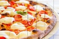 Creative picture of Pizza Margherita with Mozzarella cheese, basil and tomatoes