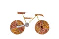 Creative picture of road bicycle made of international pizza and vegetables on white background. Delivery. Royalty Free Stock Photo