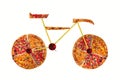 Creative picture of road bicycle made of international pizza and vegetables on white background. Delivery. Royalty Free Stock Photo