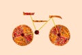 Creative picture of road bicycle made of international pizza and vegetables on white background. Delivery. Royalty Free Stock Photo