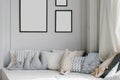 Creative pillows in the children`s room on the catwalk and frames with empty space, mockups on the wall in the house Royalty Free Stock Photo