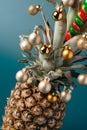 Creative pineapple with Christmas decorations on studio background