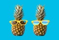 Creative pineapple with sunglasses isolated on blue background, summer vacation beach idea copy space