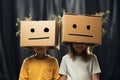 Creative play two little girls wearing cardboard boxes on their heads