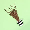 Creative pop art cup of coffee pastel coloured background. Coffee mug and roasted coffee beans.