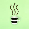 Creative pop art cup of coffee pastel coloured background. Coffee mug and roasted coffee beans. Royalty Free Stock Photo