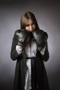 Creative portrait of a sad, tired businesswoman in boxing gloves. Gray background Royalty Free Stock Photo