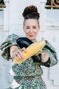 Creative portrait of vegan woman holding vegetables. Veganism, vegetarianism, plant-based diet