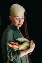 Creative portrait of vegan woman holding vegetables. Veganism, vegetarianism, plant-based diet