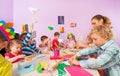 Creative preschool children with teacher