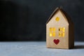 Creative present box, cardboard house with lights inside and red heart as symbol of love