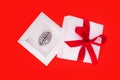 Creative present to a genius in form of a small steel copy of a human brain inside a white gift box with a red ribbon and bow on