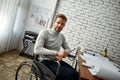 Creative professional. Portrait of young confident male architect in a wheelchair looking at camera while working with Royalty Free Stock Photo