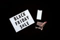 Creative promotion composition Black friday sale text on lightbox on black background, next grocery trolley, mobile phone. Flat Royalty Free Stock Photo