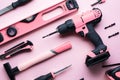 Creative provocation: a flat layout of pink hand tools on a pink background. Royalty Free Stock Photo