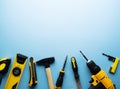Creative provocation: a flat layout of yellow hand tools on a blue background. Royalty Free Stock Photo