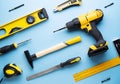 Creative provocation: a flat layout of yellow hand tools on a blue background. Royalty Free Stock Photo