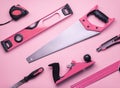 Creative provocation: a set of hand tools for construction and repair on a pink background. Royalty Free Stock Photo