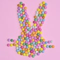 Creative rabbit bunny head made with colorful candies on pastel pink background. Flat lay Easter concept Royalty Free Stock Photo