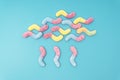 Creative raining cloud flat lay made of colored sugar coated gummy worms on a light blue background Royalty Free Stock Photo