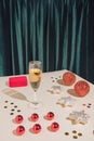 Creative retro aesthetic concept. Minimal New Year party composition with jewelry box, champagne glass, confetti and red Christmas