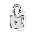A creative retro distressed sticker of a caroon rusty old padlock Royalty Free Stock Photo