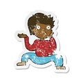 A creative retro distressed sticker of a cartoon boy doing crazy dance